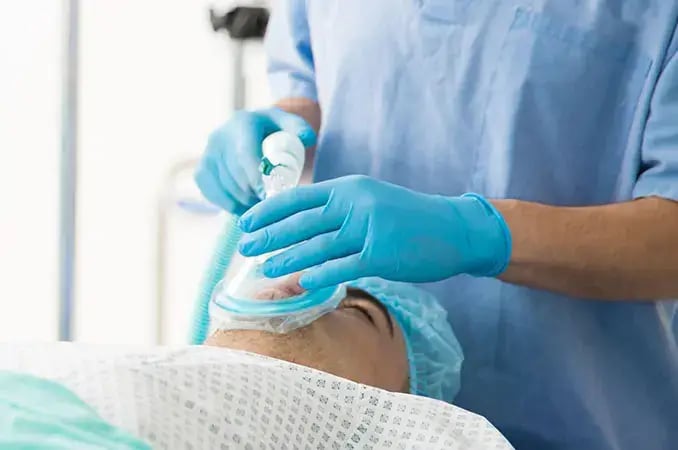 Anesthesia tech with patient in OR Anesthesia tech with patient in OR