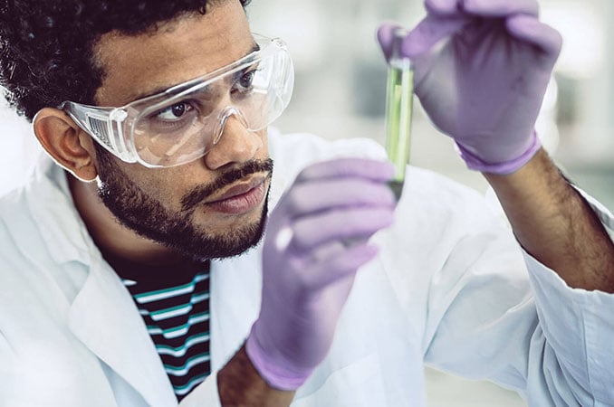 Clinical Lab Scientist with test tubes in a lab Clinical Lab Scientist with test tubes in a lab