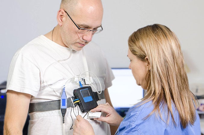 Sleep tech nurse applying monitor to a patient Sleep tech nurse applying monitor to a patient