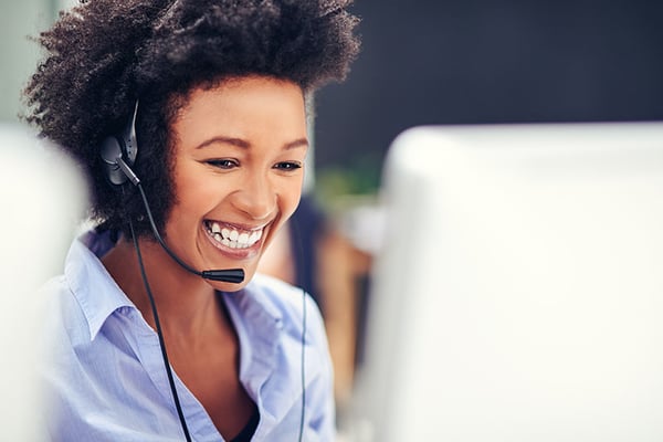 Recruiter with a headset at a computer talking to a healthcare traveler Recruiter with a headset at a computer talking to a healthcare traveler